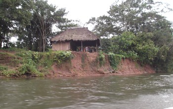 A family home on a low bluff above an Amazonian river.